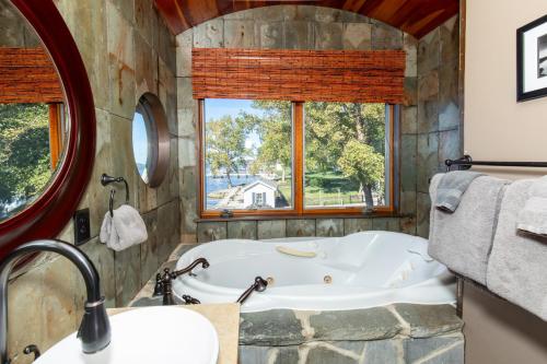 a large bathroom with a tub and a window at Waterfront Luxury Family Retreat in Sandusky