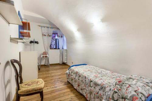 サン・フェリーチェ・デル・ベナーコにあるAppartamento Lunaのベッドと椅子のある寝室