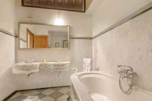 a white bathroom with a tub and a sink at Fattoria la Gigliola - La Terrazza in Montespertoli