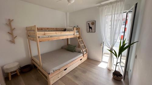 a bunk bed in a room with a window at Casa Lydia in Torrox Costa