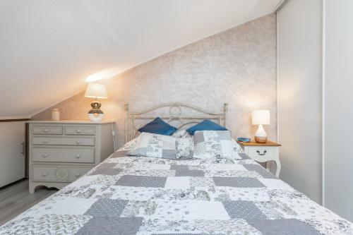 a bedroom with a large bed with blue pillows at Residence naturiste Eden in Leucate