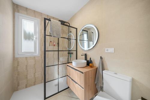 a bathroom with a sink and a mirror at Villa Susanna in Benalmádena