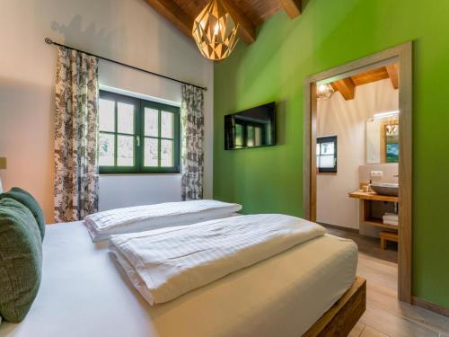 two beds in a bedroom with green walls at Wagrainer TauernLodge 42D in Wagrain