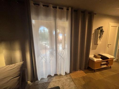 een slaapkamer met een groot raam met witte gordijnen bij Love Room L Interlude in Vitrolles