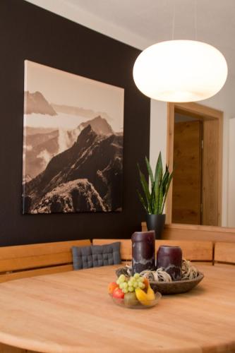 a table with a bowl of fruit on top of it at Haus Arnold - Privatzimmer und Ferienwohnungen in Sillian