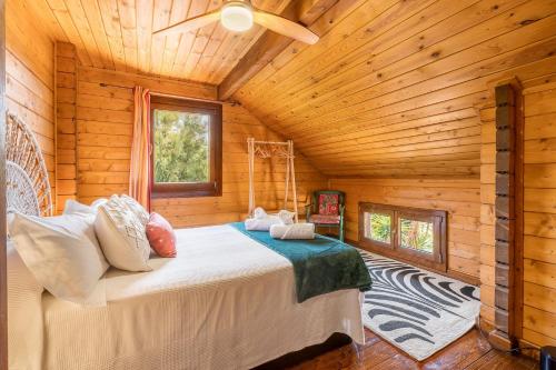 a bedroom with a bed in a wooden cabin at Finca La Haima in Motril