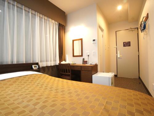a hotel room with a bed and a desk at Hotel Trend Asakusa in Tokyo
