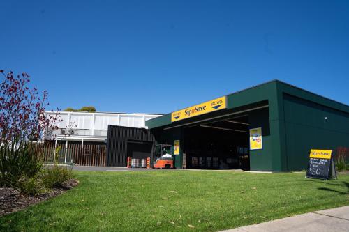 a green building with a sign in front of it at Lockleys Hotel in Adelaide