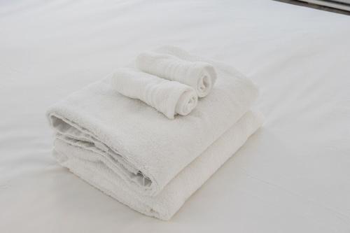 a pile of towels sitting on top of a mirror at Spacious and Cozy 1BR - Near Old Port in Montréal