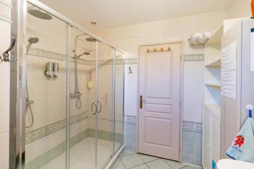 a shower with a glass door in a bathroom at Les Chambres D'arrauntz in Ustaritz