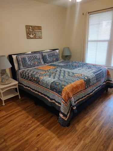 a bedroom with a bed and a table and a window at Baywatch in Clearwater