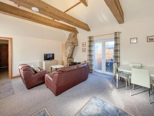 a living room with a couch and a table at The Pottery in Horncastle