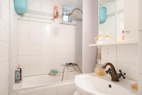 a bathroom with a sink and a bath tub at Villa Maria and Dimosthenis in Kalamata