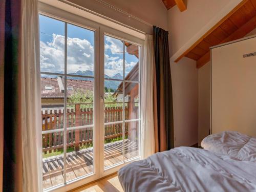 a bedroom with a large window with a view at Gailblick in Kötschach