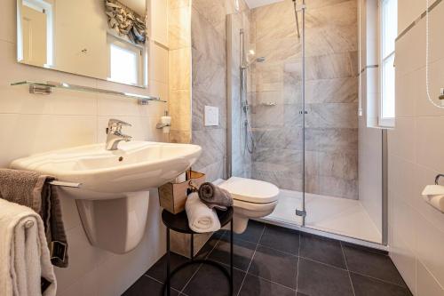 a bathroom with a sink toilet and a shower at Alpen Living 1 Stock klein in Cadipietra