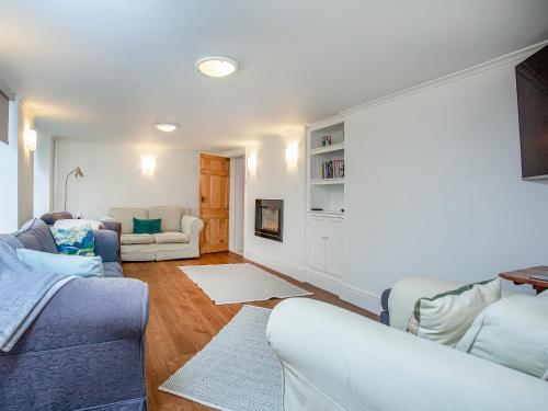a living room with two couches and a couch at Barnhay Cottage in Totnes