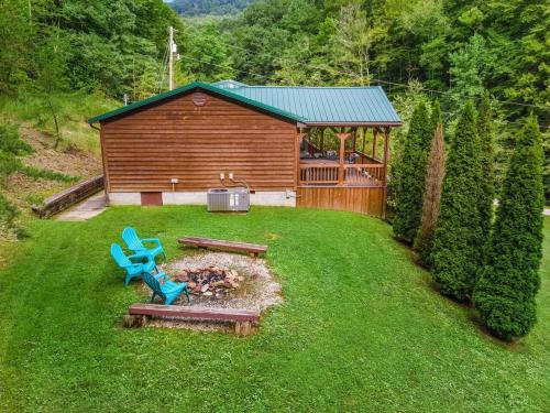 a yard with a blue bench and a cabin at Sundance Cabin with Hot Tub and WiFi in Slade
