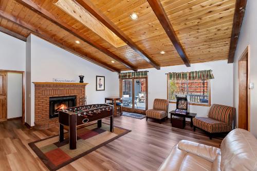 una sala de estar con una mesa y una chimenea en 118 - Pinecrest Getaway - Big Bear Getaway, en Big Bear Lake