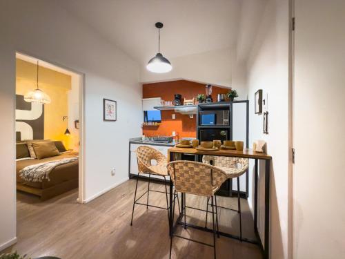 a kitchen and living room with a table and chairs at Loft in the Heart of the Historic Center in Mexico City