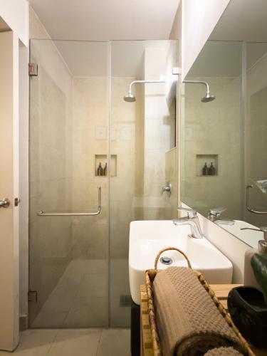 a bathroom with a sink and a glass shower at Loft in the Heart of the Historic Center in Mexico City