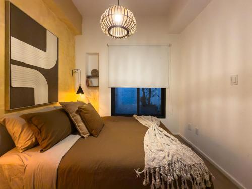 a bedroom with a bed with a large window at Loft in the Heart of the Historic Center in Mexico City