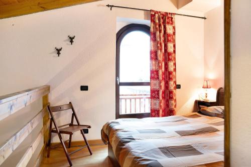 a bedroom with a bed and a window at Casa sul Fiume-zona Limone Piemonte in Vernante