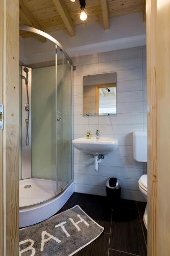 a bathroom with a shower and a sink and a toilet at Sun City Vízisport Paradicsom in Hódmezővásárhely