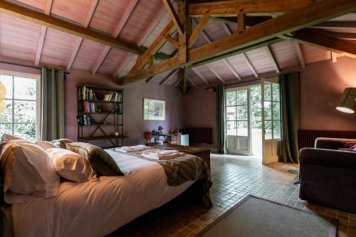 a bedroom with a large bed in a room at Villa La Maison Rose in Saint-Julien-en-Born