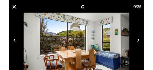 a dining room with a table and a window at Miners Lane Guest House in Clyde