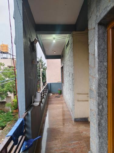 an empty hallway of a building with a bench at Hidden hampi in Hampi