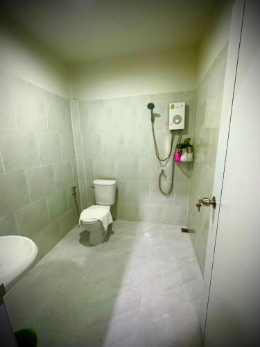 a bathroom with a toilet and a shower at Da Airport Hotel in Nai Yang Beach