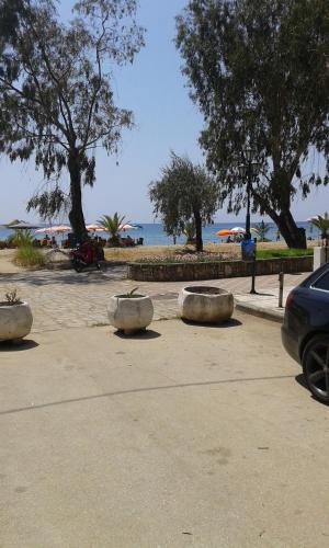 a parking lot with three cement objects on the beach at Seaside Studios in Paralia Dionysiou