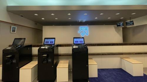 a lobby with three atm machines in a building at Toyoko Inn Kanazawa Kenrokuen Korimbo in Kanazawa