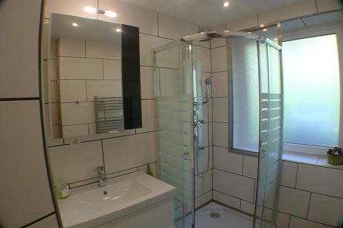 a bathroom with a glass shower and a sink at Apartment Edith Top 1 in Saalbach Hinterglemm