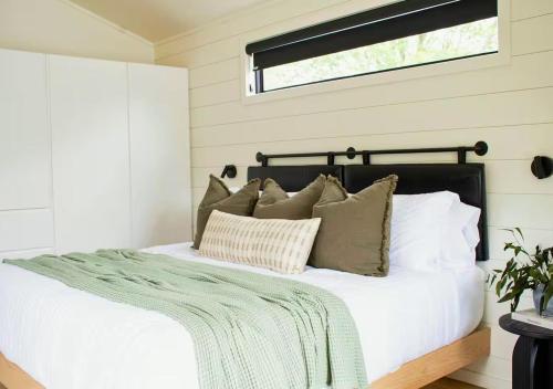 a bedroom with a bed with pillows and a window at Bay View A-Frame, Firepit, Bath Tub, Near Acadia in Gouldsboro