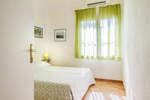 a bedroom with two beds and a window at Gianfranco in Castiglione della Pescaia