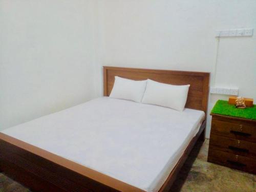 a bedroom with a white bed and a dresser at S97 Weligama in Weligama