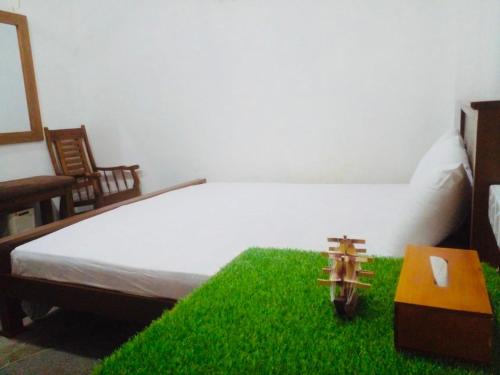 a bedroom with a large bed with green grass at S97 Weligama in Weligama