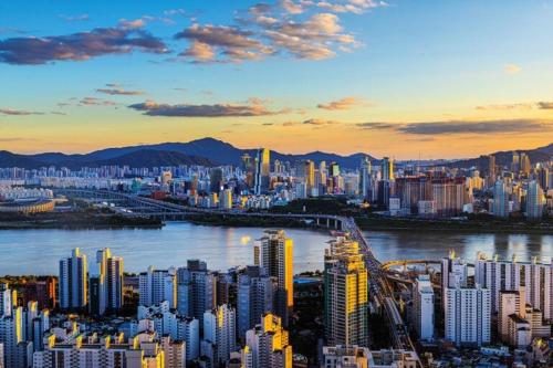 a view of a city with a river and buildings at Namsan Nest in Seoul