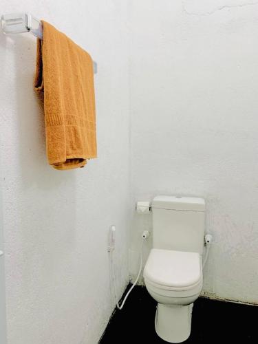 a bathroom with a toilet with an orange towel at S97 Weligama in Weligama