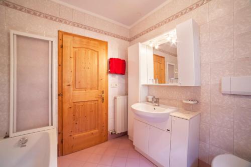 a bathroom with a sink and a toilet and a mirror at Sonnenparadies Apartement 3 in Saltusio