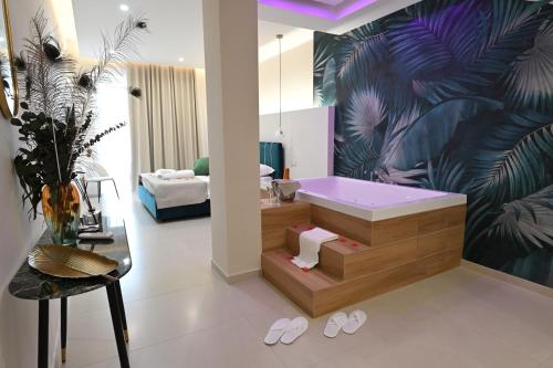 a bathroom with a tub and a large painting of a plant at Baffone Hotel in Castel Volturno