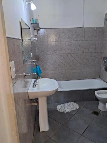 a bathroom with a sink and a tub and a toilet at La Elena in La Rioja