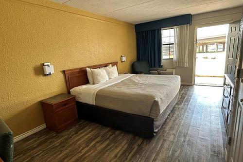 a hotel room with a bed and a window at Super 8 by Wyndham Nacogdoches Near University in Nacogdoches