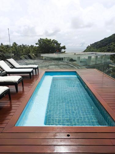 a swimming pool on the roof of a house at Twin Sands Resort Penthouse in Patong Beach
