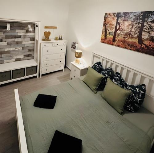 a bedroom with a large bed and a dresser at Fewo-Romuli in Eggesin