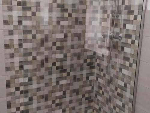 a shower with a glass door in a bathroom at Gîte Moderne avec Piscine Couverte Partagée à Chalain-le-Comtal - FR-1-496-236 in Chalain-le-Comtal