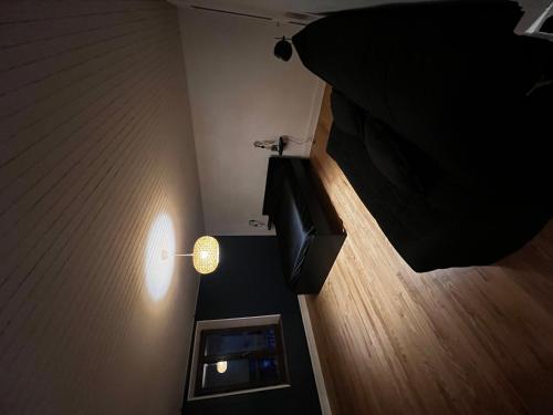 a room with a bed and a table with a lamp at Nature et Calme Entre Deux Lacs in La Biolle