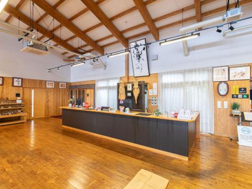 a large room with a counter in the middle at Tabist Fontana no Oka Kamou in Aira