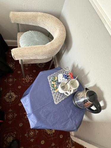 a room with a table and a chair at Tuxford House in Blackpool